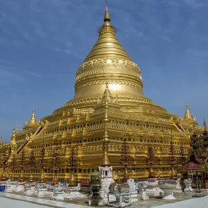 A circular gold leaf-gilded stupa at Buddhist temple The Shwezigon Pagoda or Shwezigon Paya