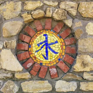 Circular mosaic religious symbol of confucianism on stone wall Circular mosaic religious symbol of confucianism on stone wall