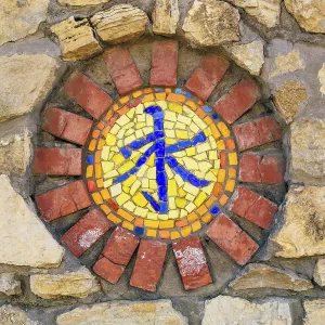 Circular mosaic religious symbol of confucianism on stone wall Circular mosaic religious symbol of confucianism on stone wall