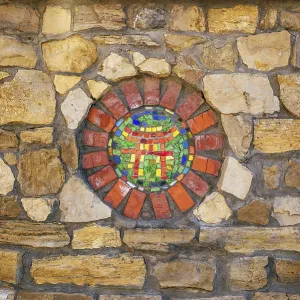 Circular mosaic religious symbol of Shinto on stone wall Circular mosaic religious symbol of Shinto on stone wall