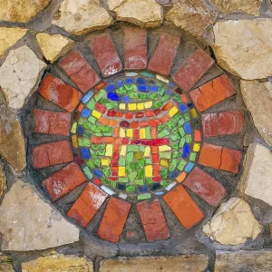 Circular mosaic religious symbol of Shinto on stone wall Circular mosaic religious symbol of Shinto on stone wall