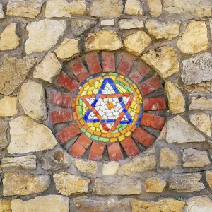Circular mosaic religious symbol Star of David on stone wall Circular mosaic religious symbol Star of David on stone wall