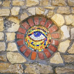 Circular mosaic symbol Eye of Horus on stone wall Circular mosaic symbol Eye of Horus on stone wall