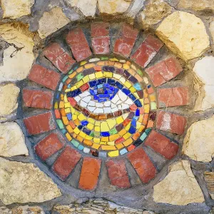 Circular mosaic symbol Eye of Horus on stone wall Circular mosaic symbol Eye of Horus on stone wall