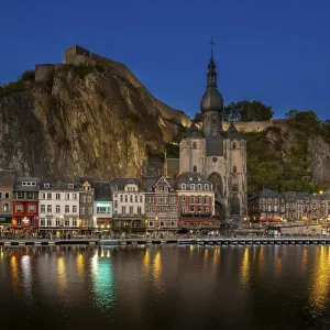 Citadel and 13th-century Collegiate Church of Notre Dame de Dinant in the city along the river Meuse at dusk Citadel and 13th-century Collegiate Church of Notre Dame de Dinant in the city along the river Meuse at dusk