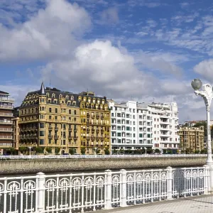City landscape with classic building facades along a river and blue sky with clouds City landscape with classic building facades along a river and blue sky with clouds