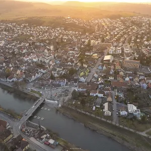 City along a river, illuminated by soft evening sun