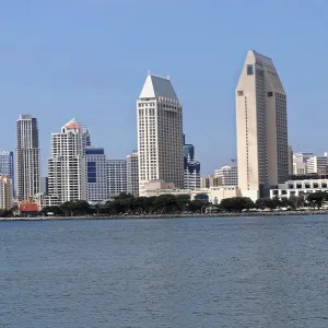 City skyline with modern buildings and water in the foreground