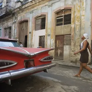 Classic car parked in a rundown street Classic car parked in a rundown street