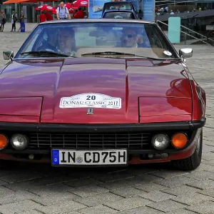Classic red car seen from the front at a classic car event on the road