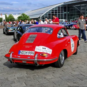 Classic red Porsche at a classic car rally