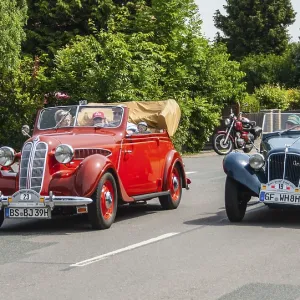 Two classic vintage cars, a red and a blue car
