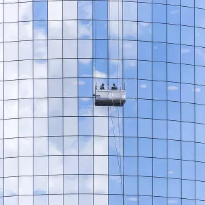 Two cleaners washing the windows of modern skyscraper in New York Two cleaners washing the windows of modern skyscraper in New York