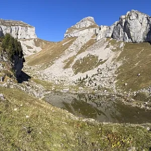 Cliffs at Tour de Mayen with a small mountain lake Lac de Mayen