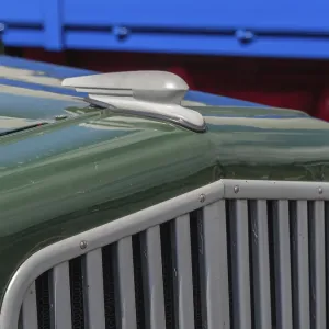 Close-up of a green classic car with distinctive radiator grille and bodywork details