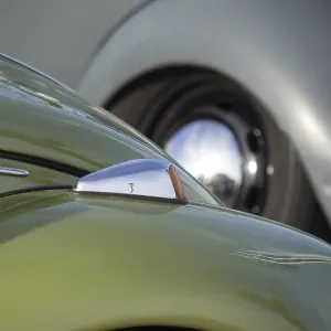 Close-up of a green vintage car with shiny chrome and headlights Close-up of a green vintage car with shiny chrome and headlights