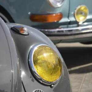 Close-up of a grey vintage car with yellow headlights Close-up of a grey vintage car with yellow headlights