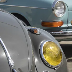 Close-up of a grey vintage car with yellow headlights Close-up of a grey vintage car with yellow headlights