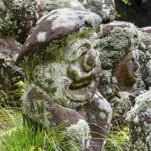 Close-up of moss-covered stone statue of rakan Close-up of moss-covered stone statue of rakan