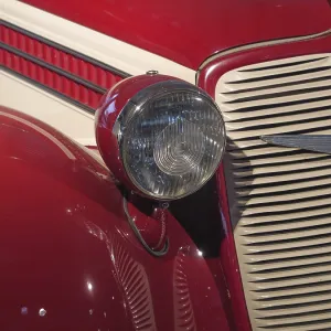 Close-up of a red vintage car with headlights