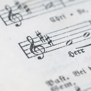 Close-up of a sheet music with musical symbols and text in black and white Close-up of a sheet music with musical symbols and text in black and white