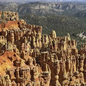 Close-up of textured red rock walls and sweeping views across green valleys