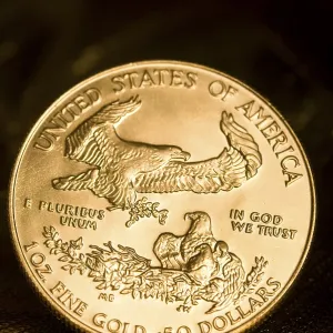 A close-up view of an American gold coin with an eagle and inscriptions