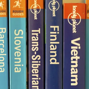 Close up of various travel guide books published by Lonely Planet and Rough Guides Close up of various travel guide books published by Lonely Planet and Rough Guides
