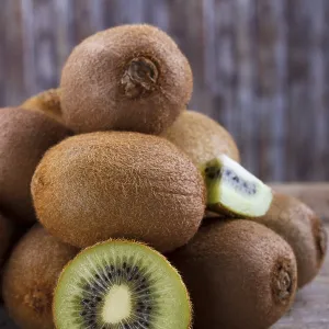 Closeup of ripe kiwi on old rustic wooden table Closeup of ripe kiwi on old rustic wooden table