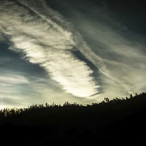 Cloud patterns swirl dramatically in the twilight sky Cloud patterns swirl dramatically in the twilight sky