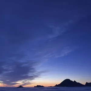 Clouds and mountain peaks, view from Offersoykammen at dusk