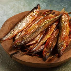 Cold smoked capelin, on a wooden bowl