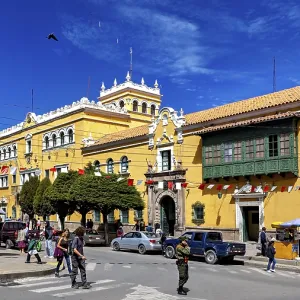 Colonial-style building with market scene and decorative flags Colonial-style building with market scene and decorative flags