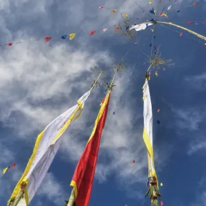 Colorful buddhist prayer flags and standards on poles in Pathivara Devi