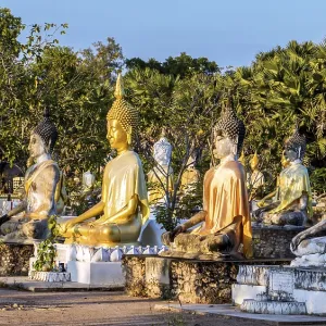 A colorful group of Buddha statues at the Buddhist Cemetery
