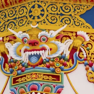 A colorful temple style dragon wall of ornamentation and Buddhist symbols A colorful temple style dragon wall of ornamentation and Buddhist symbols