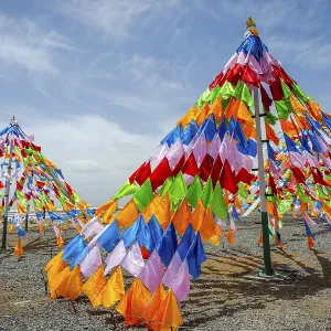 Colorful tibetan buddhist praying flags in the wind next to Chaqia salt lake Colorful tibetan buddhist praying flags in the wind next to Chaqia salt lake