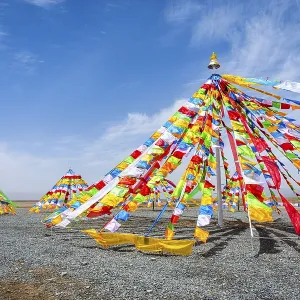 Colorful tibetan buddhist praying flags in the wind next to Chaqia salt lake Colorful tibetan buddhist praying flags in the wind next to Chaqia salt lake