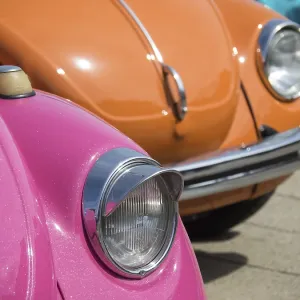 Colourful classic cars with shiny headlights in the sun Colourful classic cars with shiny headlights in the sun