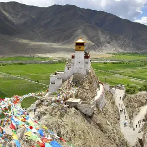 Colourful prayer flags wave on a mountain at fortress Yumbulagang in Yarlung valley near Tsetang Tibet China