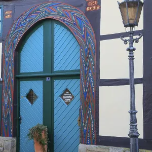 Colourfully painted gate entrance of a 16th century half-timbered house in BackerstraBe Colourfully painted gate entrance of a 16th century half-timbered house in BackerstraBe