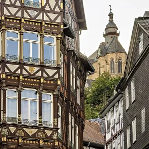 Combination of elaborate half-timbered details and Gothic church tower in the cityscape Combination of elaborate half-timbered details and Gothic church tower in the cityscape