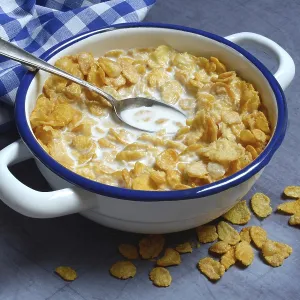 Cornflakes with milk in bowl, breakfast