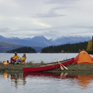 Couple around a campfire, canoeing