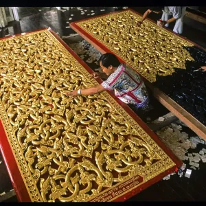Craftsmen gilding doors with gold leaf Craftsmen gilding doors with gold leaf