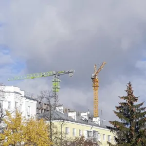 Two cranes tower over the houses