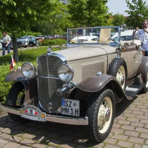 Cream-coloured convertible in a sunny ambience Cream-coloured convertible in a sunny ambience