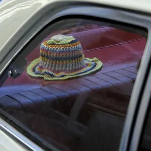 Crocheted toilet paper hat on the stacking of a vintage car Crocheted toilet paper hat on the stacking of a vintage car