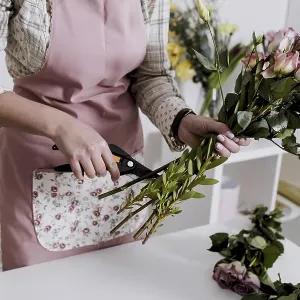 Crop florist preparing flowers Crop florist preparing flowers