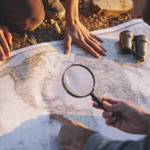 Crop man exploring map